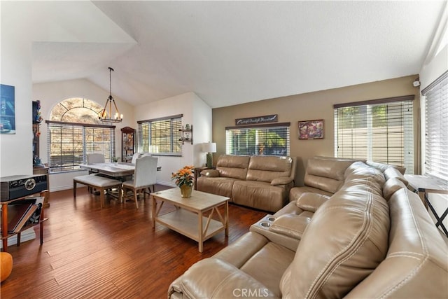 living room featuring a chandelier, dark hardwood / wood-style floors, and lofted ceiling