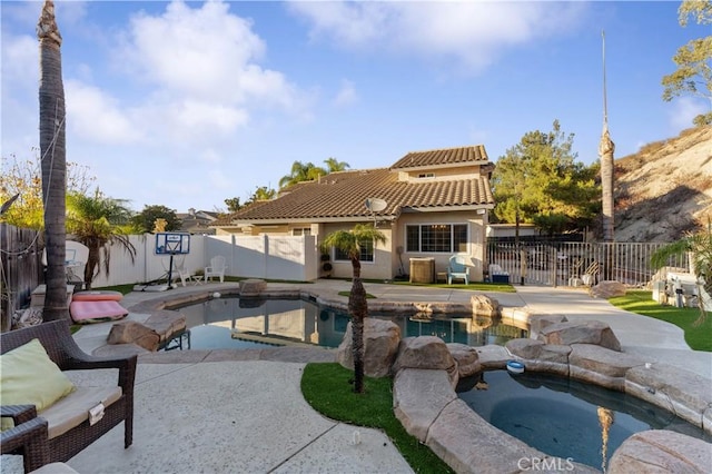 view of swimming pool featuring an in ground hot tub and a patio