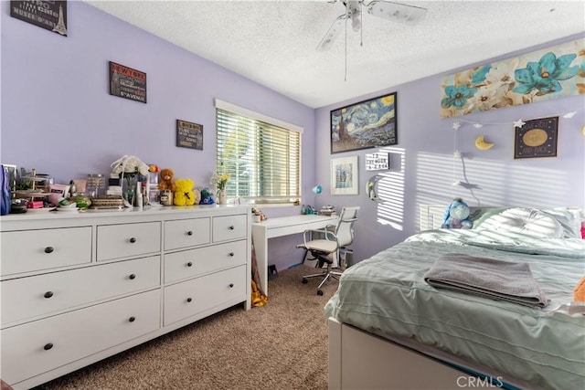 bedroom featuring ceiling fan, light colored carpet, and a textured ceiling