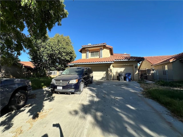 mediterranean / spanish house with a garage