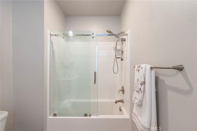 bathroom with toilet and enclosed tub / shower combo