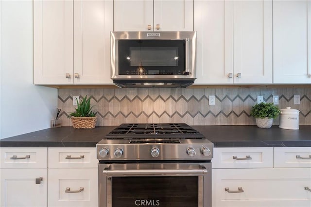 kitchen with white cabinets, backsplash, and appliances with stainless steel finishes