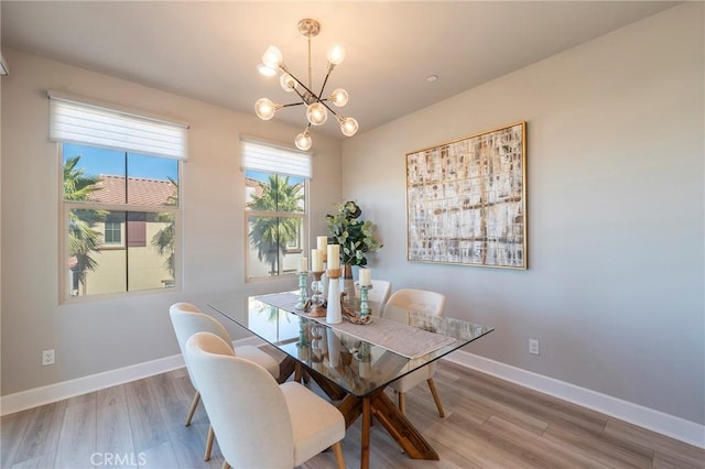 dining area featuring a chandelier and wood-type flooring