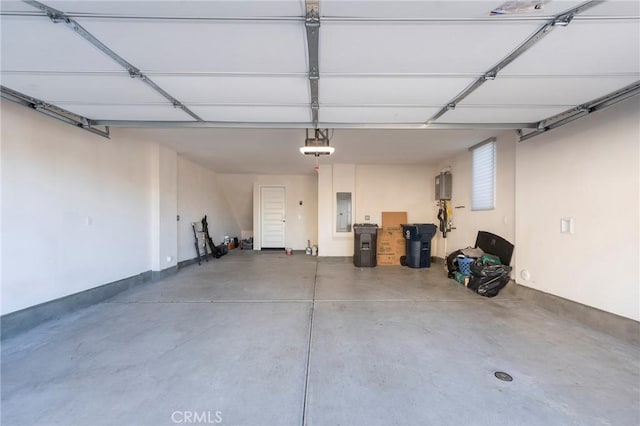 garage with electric panel and a garage door opener