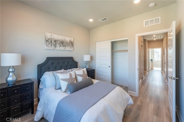 bedroom with hardwood / wood-style flooring and a closet