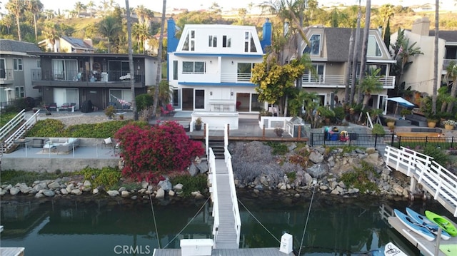 exterior space featuring a water view and a dock