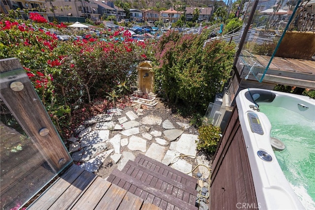 deck featuring an outdoor hot tub