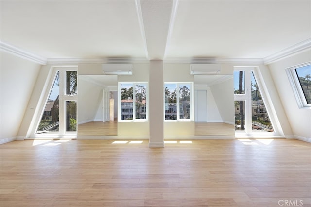 unfurnished living room featuring an AC wall unit, ornamental molding, and light hardwood / wood-style flooring