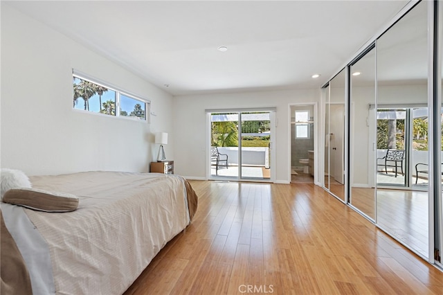 bedroom with access to outside, a closet, light hardwood / wood-style flooring, and ensuite bathroom