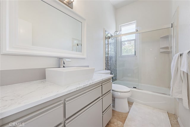 full bathroom with vanity, toilet, and enclosed tub / shower combo