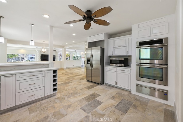 kitchen with white cabinets, ceiling fan, pendant lighting, and appliances with stainless steel finishes