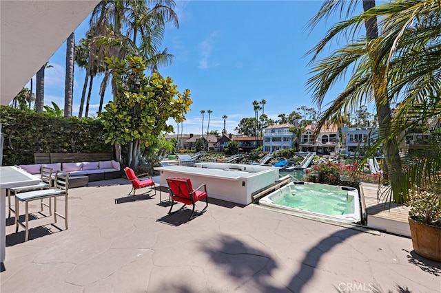 exterior space featuring an outdoor hangout area and an outdoor hot tub