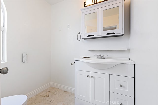 bathroom featuring toilet, vanity, and tile patterned floors