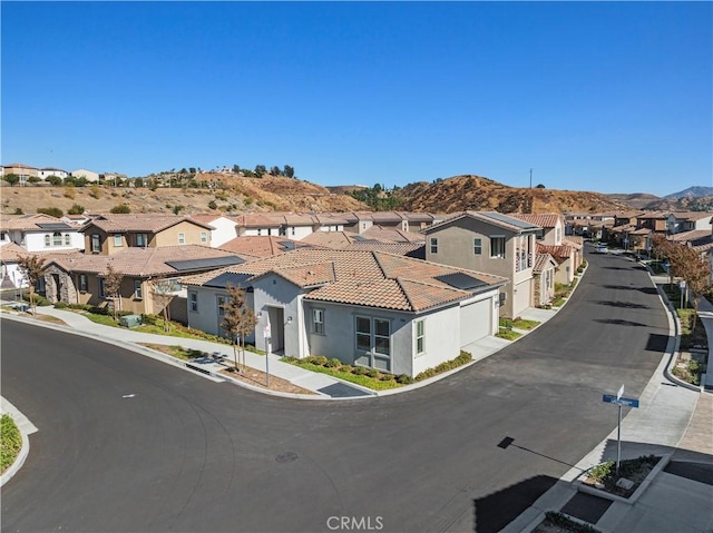 birds eye view of property featuring a mountain view