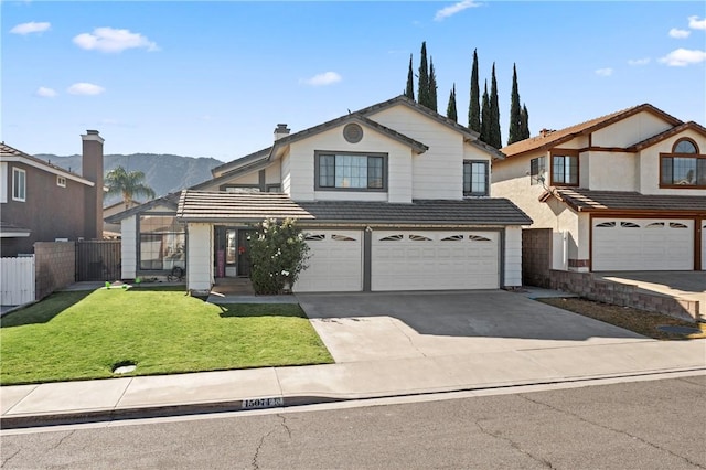 view of property with a mountain view, a garage, and a front lawn