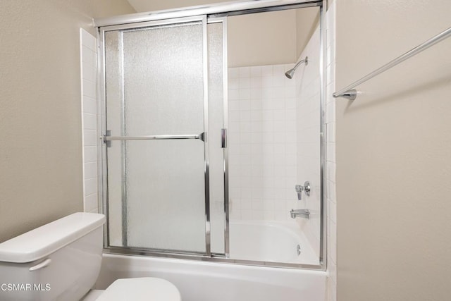 bathroom featuring shower / bath combination with glass door and toilet