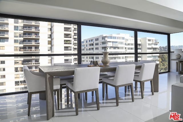 tiled dining room with expansive windows