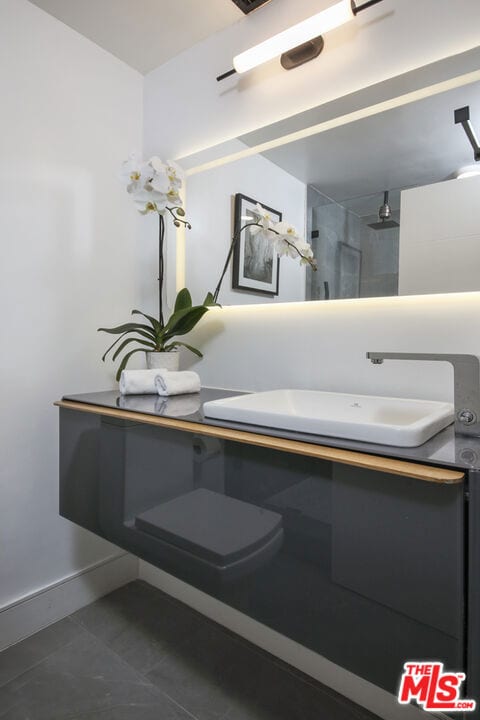 bathroom featuring a tile shower and tile patterned flooring