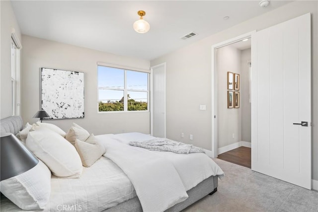 bedroom featuring carpet, visible vents, and baseboards