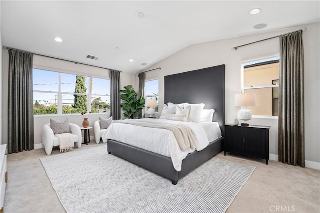 bedroom featuring light colored carpet and lofted ceiling