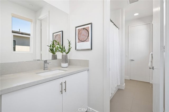 bathroom with tile patterned floors, recessed lighting, and vanity