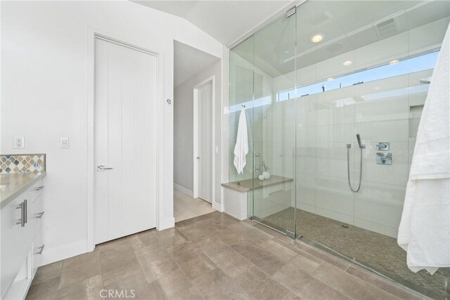 bathroom with tile patterned flooring, vanity, and an enclosed shower