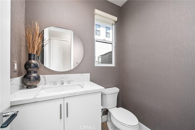 bathroom with toilet and vanity