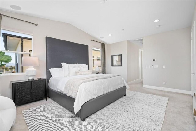 bedroom with light carpet and vaulted ceiling