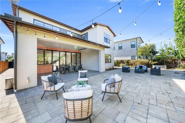 view of patio featuring fence and outdoor lounge area