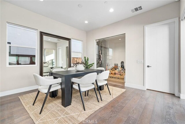 dining space with wood-type flooring