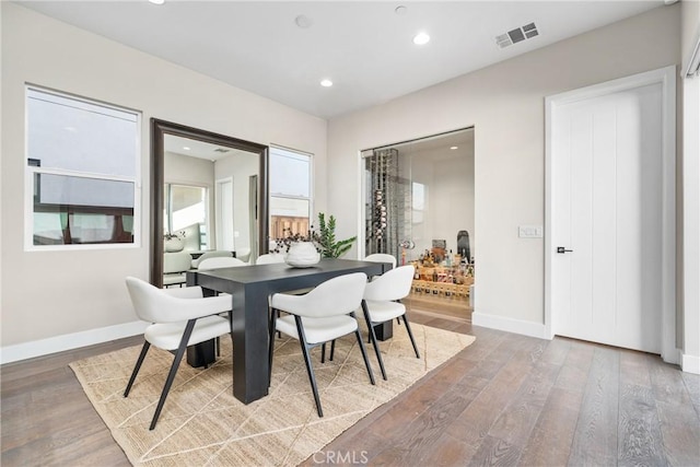 dining area featuring recessed lighting, visible vents, baseboards, and wood finished floors