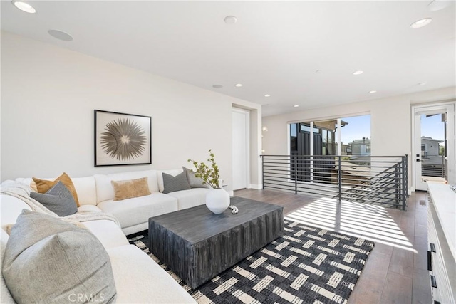 living room featuring dark wood-type flooring and recessed lighting