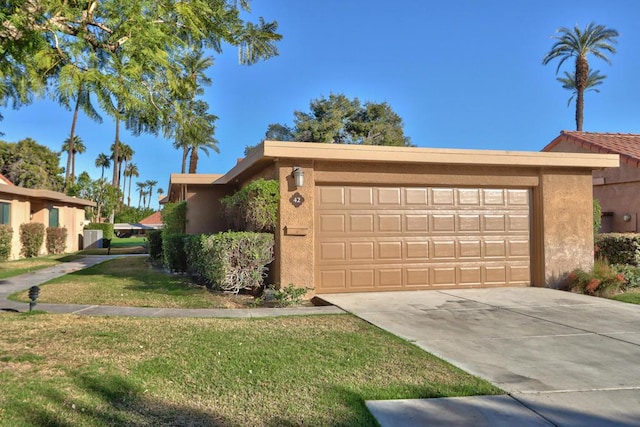 view of front of home with a front lawn and a garage