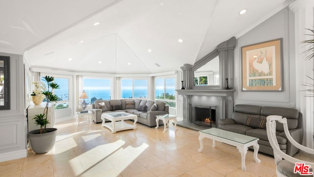 living room featuring a water view, a healthy amount of sunlight, and lofted ceiling