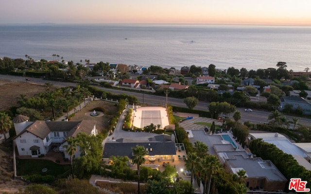 aerial view at dusk with a water view