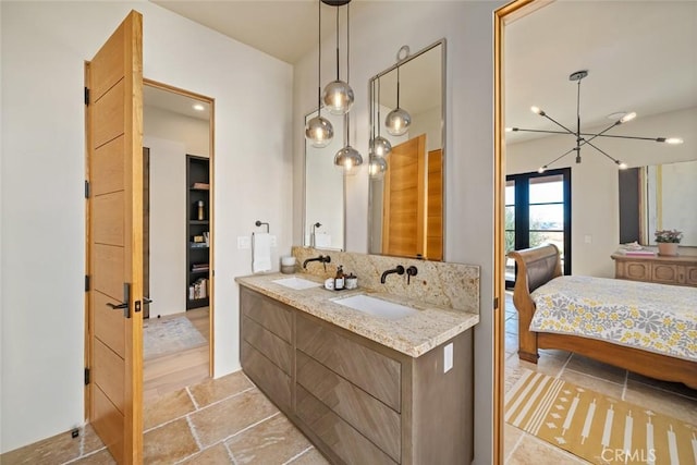 bathroom featuring decorative backsplash, hardwood / wood-style floors, vanity, and a chandelier