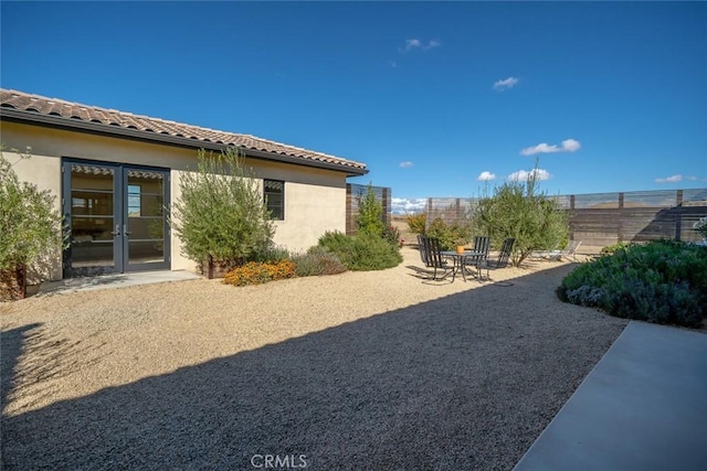 view of yard featuring french doors and a patio