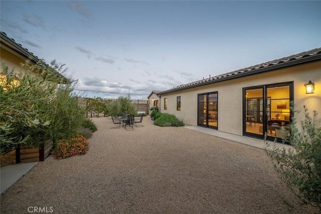 yard at dusk with a patio area