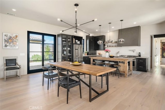 dining area featuring a chandelier and light hardwood / wood-style floors