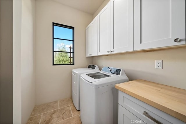 washroom featuring cabinets and independent washer and dryer