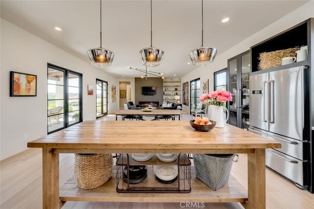 kitchen with pendant lighting, light wood-type flooring, and high quality fridge