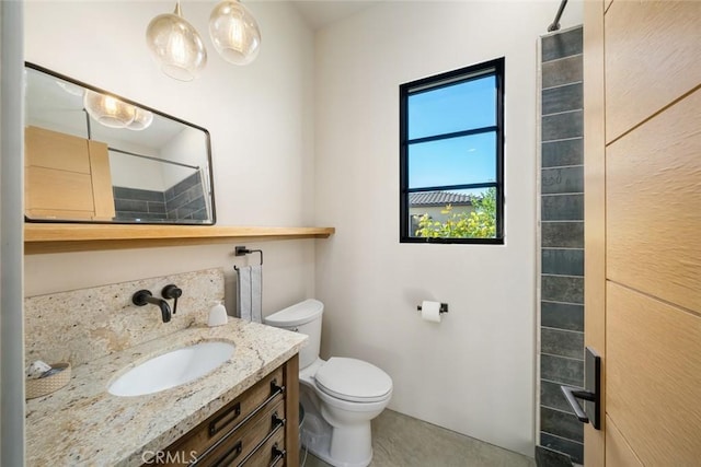 bathroom featuring vanity, toilet, and walk in shower