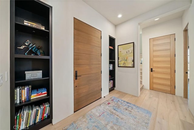 hallway with hardwood / wood-style flooring