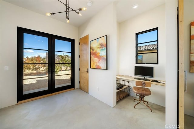 entryway featuring french doors, light colored carpet, and a notable chandelier