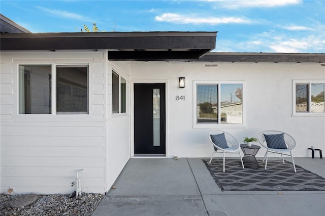 entrance to property featuring a patio