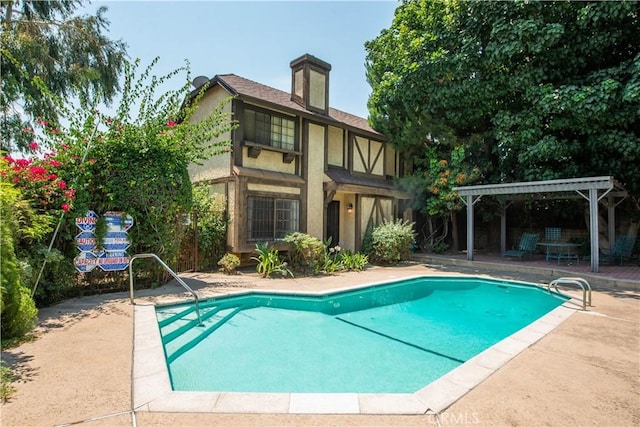 view of pool featuring a pergola and a patio