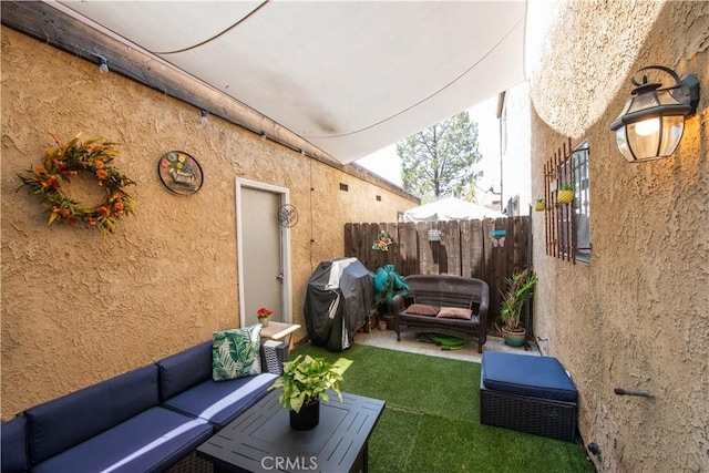 view of patio with outdoor lounge area and grilling area