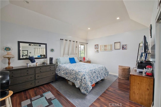 bedroom with a raised ceiling and dark wood-type flooring