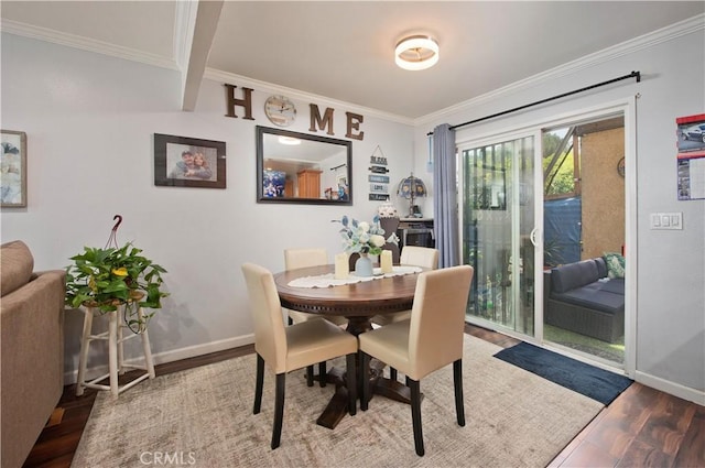 dining area featuring hardwood / wood-style floors, beam ceiling, and crown molding