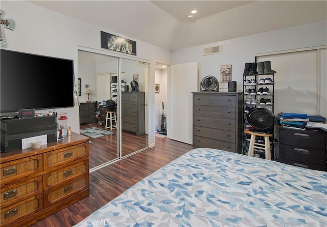 bedroom featuring dark hardwood / wood-style floors, a closet, and lofted ceiling